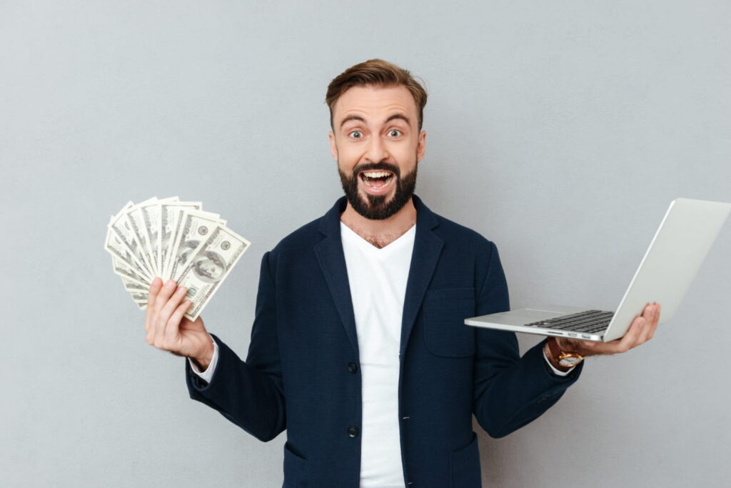 american men holding money and laptop