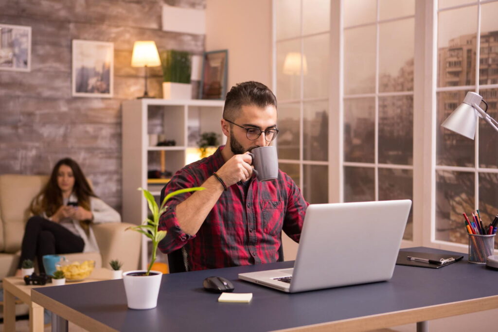 men working on laptop while drinking tea