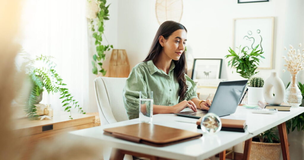 girl doing work on laptop in office