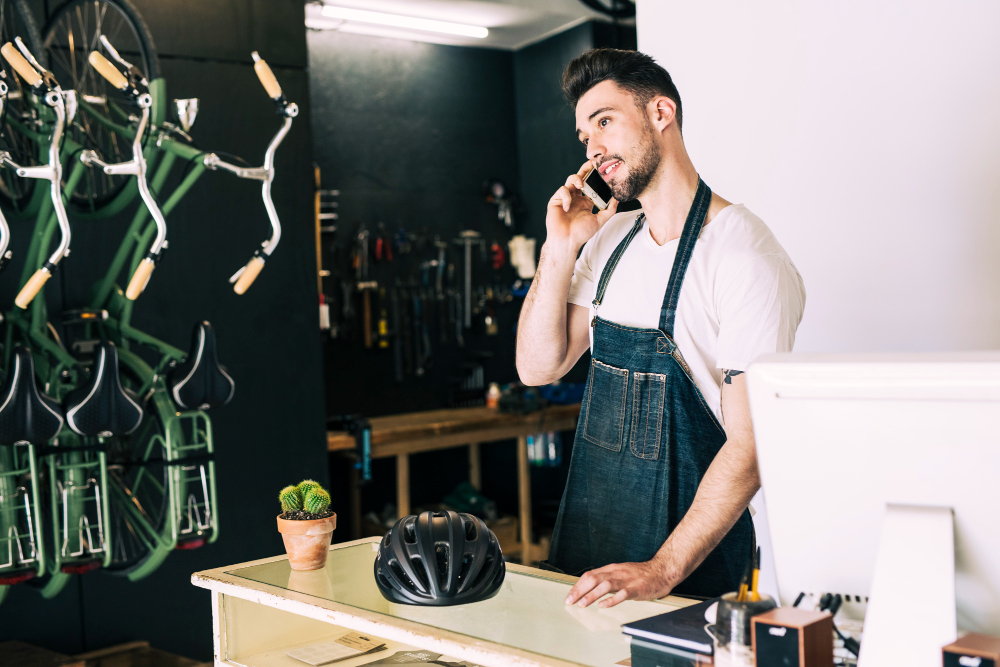 a local business owner talking on call while working in shop