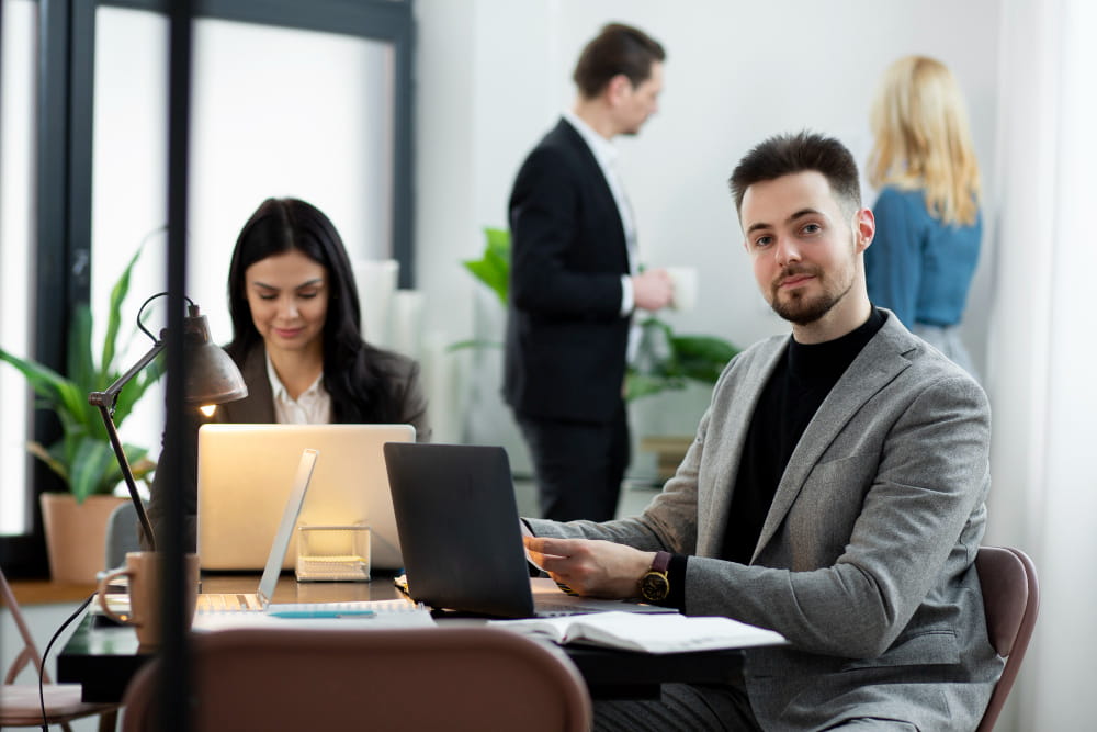 two cowerkers work together in office